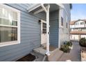 Side entrance featuring a white door and concrete steps, providing a welcoming entry at 10470 W 83Rd Ave, Arvada, CO 80005