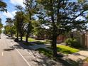 Beautiful tree-lined street with well-maintained lawns and sidewalks, creating a picturesque neighborhood scene at 3739 W 46Th Ave, Denver, CO 80211