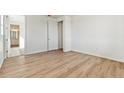 Spacious bedroom featuring laminate flooring, neutral walls, and an open door at 4495 Boone Cir, Brighton, CO 80601