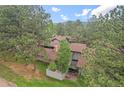 Aerial shot of a home featuring a fenced patio and lush green surroundings at 2378 Hearth Dr # 20, Evergreen, CO 80439