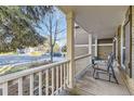 Cozy covered porch with outdoor seating, offering a relaxing view of the neighborhood street at 7273 E Hinsdale Pl, Centennial, CO 80112