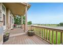 Spacious covered porch with decorative planters and a view of a baseball field at 9770 Dahlia Ln, Thornton, CO 80229