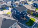 Backyard aerial view showcasing a white fence, a patio, and a gravel-filled landscaped area at 4851 Cattle Cross Rd, Castle Rock, CO 80104