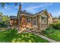 A charming brick home with a well-manicured lawn and inviting front entrance porch at 521 Harrison St, Denver, CO 80206