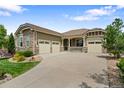 Attractive home with a three-car garage and large concrete driveway on a sunny day at 10182 Bristleridge St, Parker, CO 80134