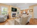 Inviting living room with a fireplace, hardwood floors, and a view into the kitchen at 10182 Bristleridge St, Parker, CO 80134