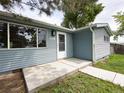 Close up of the front exterior of the home featuring blue siding and a white front door at 10025 W 8Th Ave, Lakewood, CO 80215