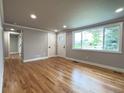 Bright living room with hardwood floors, gray walls, and large windows providing plenty of natural light at 10025 W 8Th Ave, Lakewood, CO 80215