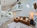 Open living room with lofted area and hardwood floors at 4737 N Bearlily Way, Castle Rock, CO 80109