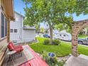 Cozy backyard with a red deck, a small table set, and a view of the surrounding neighborhood at 9150 Garrison St, Broomfield, CO 80021