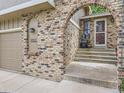 Inviting home entrance with brick archway, house number, and steps leading to the front door at 9150 Garrison St, Broomfield, CO 80021