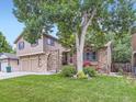 Charming two-story home with a lush green lawn and mature trees, creating a welcoming atmosphere at 9150 Garrison St, Broomfield, CO 80021