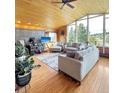 Bright living room featuring wood ceilings, large windows and stylish neutral decor at 22155 Cook Ln, Morrison, CO 80465