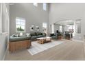 Bright living room with high ceilings and large windows at 7606 S Valleyhead Ct, Aurora, CO 80016