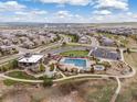 Aerial view of the neighborhood community pool with clubhouse, playground and many homes at 14710 Domino Dr, Parker, CO 80134