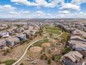 Aerial view of a neighborhood with homes, playgrounds and common areas for residents at 14710 Domino Dr, Parker, CO 80134