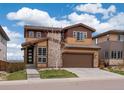 Beautiful two-story home with a two car garage, stone accents and manicured lawn at 14710 Domino Dr, Parker, CO 80134