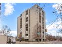 A tall building with symmetrical architecture rises with balconies and a crosswalk in front at 777 N Washington St # 304, Denver, CO 80203