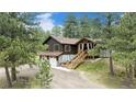 Scenic view of a charming two-story home nestled among tall pine trees at 33844 Oriole Ct, Elizabeth, CO 80107