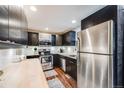 Modern kitchen with stainless steel appliances and butcher block counters at 9585 W Dakota Ave, Lakewood, CO 80226