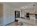 Modern kitchen with white cabinetry, stainless steel appliances, and a breakfast bar at 1540 Fawnwood Rd, Monument, CO 80132