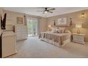 Serene main bedroom features plush carpeting, balcony access, and decorative lighting fixtures at 1540 Fawnwood Rd, Monument, CO 80132