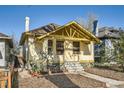 Inviting bungalow with a covered front porch, mature landscaping, and craftsman details at 2421 Hooker St, Denver, CO 80211