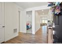 Bright entryway with hardwood floors, leading to the living area and bedroom offering a seamless transition at 8052 Mount Kataka St, Littleton, CO 80125