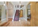 Elegant foyer featuring a grand staircase with decorative carpet and hardwood floors at 5530 E 6Th Avenue Pkwy, Denver, CO 80220
