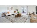 Elegant living room with contemporary decor, a cozy sofa, and a sunroom offering natural light at 3164 S Wheeling Way # 101, Aurora, CO 80014