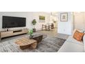 Inviting living room with stylish furniture, a sleek entertainment center, and an open-concept layout at 3164 S Wheeling Way # 101, Aurora, CO 80014