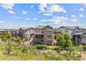 Expansive aerial view showcasing the home's backyard, including a covered patio, and a well-manicured yard with a putting green at 10401 Maplebrook Way, Highlands Ranch, CO 80126