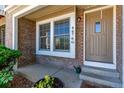 Inviting entrance features brick facade, neutral front door, and charming flower accents at 4676 S Dillon Ct # G, Aurora, CO 80015