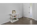 Bright entryway with a white front door, hardwood floors and modern console table at 4792 Coltin Trl, Castle Rock, CO 80104