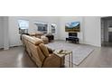 Cozy living room with large windows, a comfortable sofa, and modern decor at 4792 Coltin Trl, Castle Rock, CO 80104