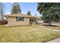 Well-kept ranch style home featuring a lush green lawn and mature trees at 3292 S Wabash Ct, Denver, CO 80231