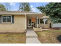 Beautiful single-story brick home featuring a covered front porch and neat landscaping at 3292 S Wabash Ct, Denver, CO 80231