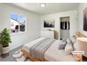 Cozy bedroom featuring a comfortable bed, closet and a large window for natural light at 9400 High St, Thornton, CO 80229