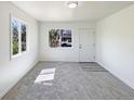 Bright living room with neutral carpet and plenty of natural light at 9400 High St, Thornton, CO 80229