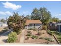A cozy single-story home featuring a xeriscaped front yard, new roof and fenced backyard at 1568 S Osceola Way, Denver, CO 80219