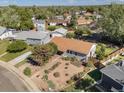 Overhead view of a quaint single-story home featuring mature trees, fenced backyard, and manicured xeriscaped yard at 1568 S Osceola Way, Denver, CO 80219