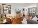 Inviting living room features hardwood floors, a mounted TV, and a comfortable seating arrangement at 1568 S Osceola Way, Denver, CO 80219