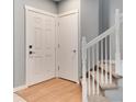 Bright entryway featuring hardwood floors, staircase, and a convenient coat closet at 12569 S Sopris Creek Dr, Parker, CO 80134