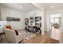 Bright home office with hardwood floors, custom shelving, and ample natural light at 13802 Quartz St, Mead, CO 80504