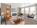 Cozy living room with a fireplace, large windows, and comfortable seating at 13802 Quartz St, Mead, CO 80504