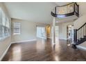 Spacious living room with hardwood floors, large windows, and an open floor plan for entertaining at 22911 E Euclid Cir, Aurora, CO 80016