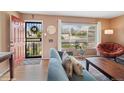 Cozy living room with hardwood floors, large windows, and comfortable seating at 2792 S Stuart St, Denver, CO 80236