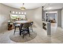 Bright dining area featuring unique windows, tile flooring and modern furnishings at 4647 W Dakota Ave, Denver, CO 80219