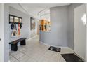 Welcoming entryway with tiled floor, a bench, and easy access to the kitchen area at 4647 W Dakota Ave, Denver, CO 80219