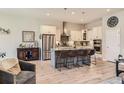 Spacious kitchen features stainless steel appliances, granite countertops, a kitchen island, and light wood flooring at 21985 E Bailey Pl, Aurora, CO 80016